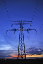 Electricity pylon against a blue evening sky