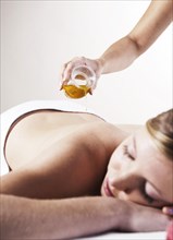 Young woman about to receive a massage with oil