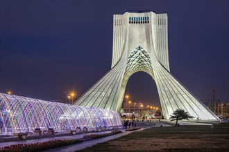 Illuminated Azadi Tower at dusk