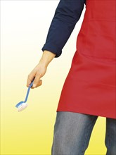 Young man wearing an apron while doing the housework