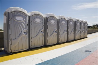 Row of portable toilets outdoors