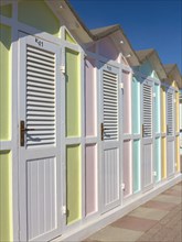 Pastel coloured beach cabins