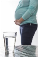 A glass water is resting on a table