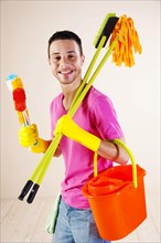 Man holding cleaning products in his hands