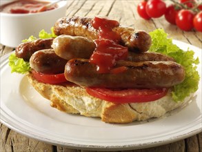 Traditional chipolata pork sausages in tomato ketchup sandwich