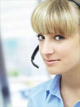 Businesswoman wearing a headset in an office