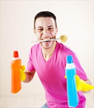 Smiling man with a cleaning brush between his teeth