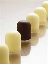 Row of chocolate-coated marshmallow treats with white chocolate