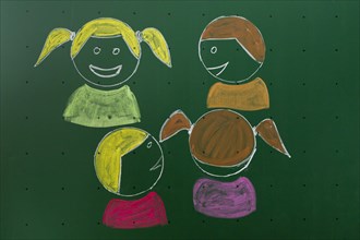 Four children drawn with chalk on a blackboard