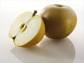 One whole and one cut Russet apple