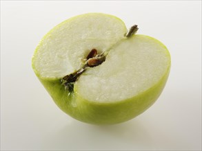 One half of a cut Bramley apple