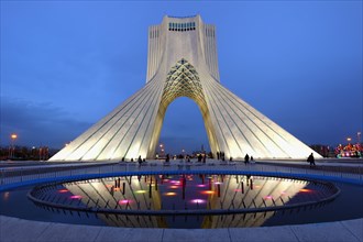 Illuminated Azadi Tower at blue hour