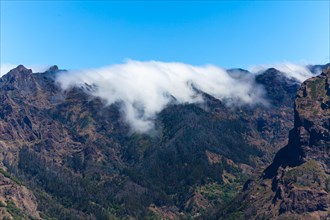 View of the mountains and deep gorges seen from Pico dos Barcelos mountain