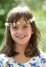 Smiling girl wearing a floral garland