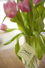 Tulips in vase with the note 'danke'