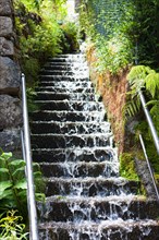 Water running down a stone staircase after a heavy rainfall
