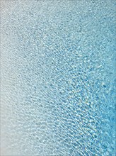 Slightly ruffled turquoise-coloured surface of water in a swimming pool