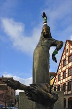 Statues wearing gloves on the Gauklerbrunnen well by artist Harro Frey