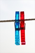Red and blue pegs on a clothesline