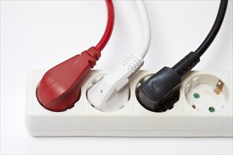 Power strip with three different coloured plugs