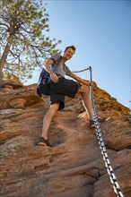 Young man hikes on Angels Landing Trail