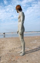 Man with a mud-covered body