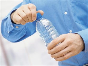 Man opening a water bottle