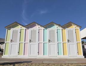 Pastel coloured beach cabins