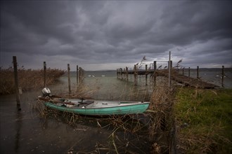 Wooden boat beside a jetty on Lake Constance