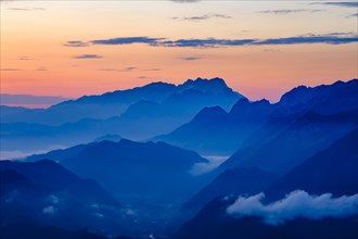 Blue mountain silhouettes at sunrise