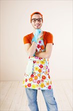 Young man wearing an apron and cleaning gloves