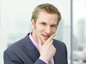 Businessman holding his hand on his chin