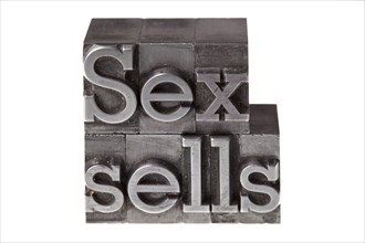 Old lead letters forming the phrase 'Sex sells'