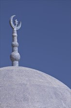 Top of a mosque with a crescent moon and a star
