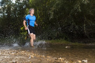 Jogger running through a stream