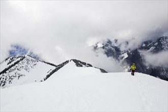 Snowshoe hiker on the summit ridge of Schoenalmjoch in the Karwendel Mountains