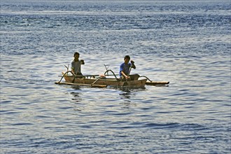 Two men in an outrigger boat