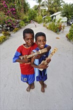 Two boys with ukulele toys