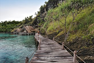 Wooden pier and water bungalows in a holiday resort