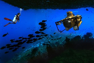 Scuba diver and a submarine in an underwater cave