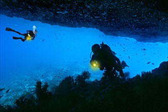 Scuba divers in an underwater cave