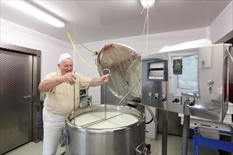 Cheesemaker during the production of goat cheese at the Goas-Alm cheese factory