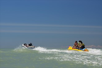 Tourists being pulled on a banana boat ride