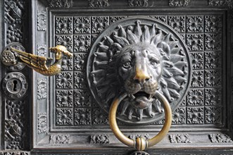 Lion head door knocker on the entrance portal