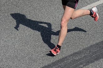 Legs and shadow of a marathon runner