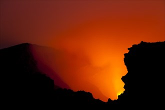 Glow of the lava lake boiling in the crater of Mount Nyiragongo volcano