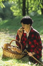 Woman with basket full of freshly picked mushrooms