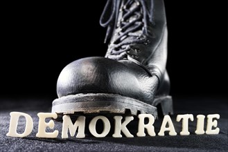 Combat boot on the word 'Demokratie'
