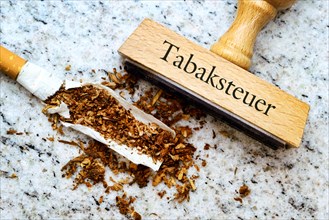 Cigarette and a stamp labelled 'Tabaksteuer'