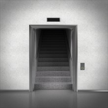 Open elevator doors revealing stairs behind them